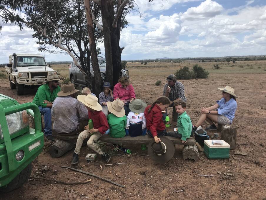 Family feed under a tree